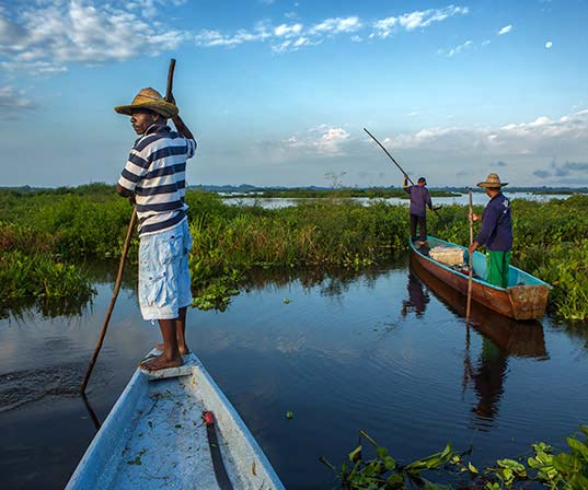 A picture of some men on some boats.